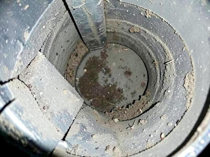 Inspection camera view inside a home air duct before cleaning, with thick grey dust coating the metal walls
